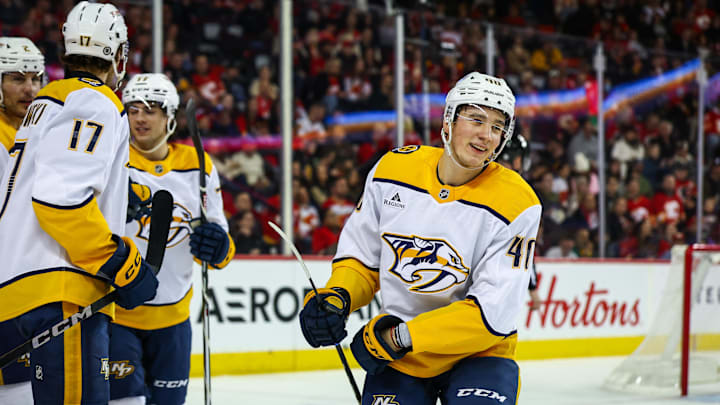 Jan 4, 2025; Calgary, Alberta, CAN; Nashville Predators center Fedor Svechkov (40) celebrates his goal with teammates against the Calgary Flames during the third period at Scotiabank Saddledome. Mandatory Credit: Sergei Belski-Imagn Images