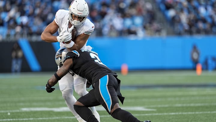 Dec 22, 2024; Charlotte, North Carolina, USA;  Arizona Cardinals wide receiver Michael Wilson (14) is tackled by Carolina Panthers cornerback Dane Jackson (23) during the second half at Bank of America Stadium. Mandatory Credit: Jim Dedmon-Imagn Images