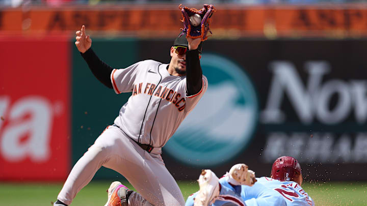 San Francisco Giants shortstop Willy Adames tags out Philadelphia Phillies center fielder Justin Crawford.