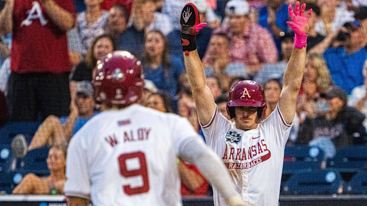 Arkansas Razorbacks third baseman Brent Iredale (10) celebrates as shortstop Wehiwa Aloy (9) scores on a two RBI double by right fielder Logan Maxwell (22) against the UCLA Bruins during the seventh inning at Charles Schwab Field. 