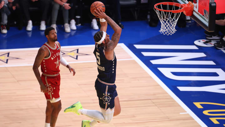 Feb 18, 2024; Indianapolis, Indiana, USA; Eastern Conference forward Paolo Banchero (5) of the Orlando Magic dunks the ball past Western Conference forward Paul George (13) of the LA Clippers during the second quarter in the 73rd NBA All-Star game at Gainbridge Fieldhouse.