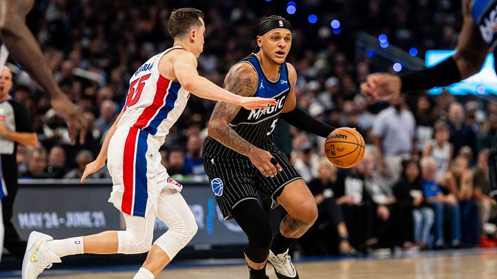 May 1, 2026; Orlando, Florida, USA; Orlando Magic forward Paolo Banchero (5) dribbles the ball against Detroit Pistons forward Duncan Robinson (55) in the fourth quarter during game six of the first round of the 2026 NBA Playoffs at Kia Center. Mandatory Credit: Jeremy Reper-Imagn Images