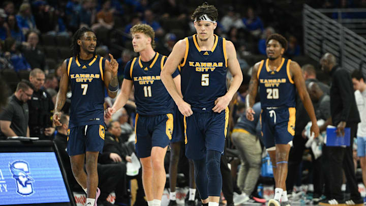 Nov 16, 2024; Omaha, Nebraska, USA;  UMKC Kangaroos guard Jamar Brown (5) leads guard Kasheem Grady II (7) and guard Anderson Kopp (11) and center Melvyn Ebonkoli (20) on the court after a timeout against the Creighton Bluejays in the second half at CHI Health Center Omaha. Mandatory Credit: Steven Branscombe-Imagn Images