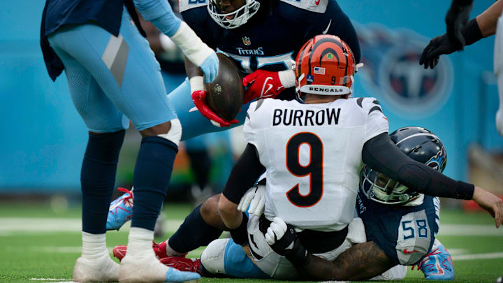 Tennessee Titans linebacker Harold Landry III (58) sacks Cincinnati Bengals quarterback Joe Burrow (9) as defensive tackle T'Vondre Sweat (93) strips the ball away during their game at Nissan Stadium in Nashville, Tenn., Sunday, Dec. 15, 2024.