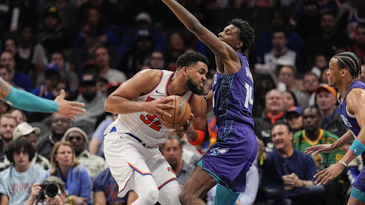 Mar 20, 2025; Charlotte, North Carolina, USA; New York Knicks center Karl-Anthony Towns (32) presses against Charlotte Hornets forward Moussa Diabate (14) during the second half at Spectrum Center. Mandatory Credit: Jim Dedmon-Imagn Images