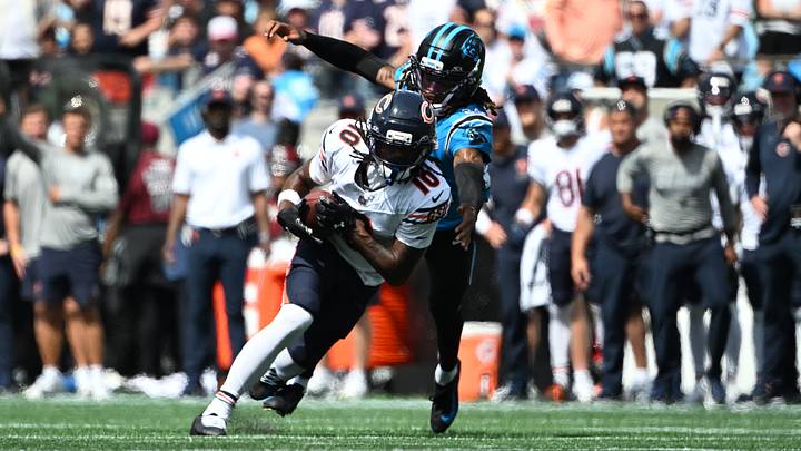 Chicago Bears wide receiver Luther Burden III (10) runs the ball while defended by Carolina Panthers cornerback Will Lee III (24) in the second quarter at Bank of America Stadium.  Mandatory Credit: Bob Donnan-Imagn Images