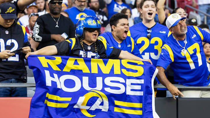 Dec 7, 2025; Glendale, Arizona, USA; Los Angeles Rams fans in the crowd celebrate a touchdown against the Arizona Cardinals during the second half at State Farm Stadium. Mandatory Credit: Mark J. Rebilas-Imagn Images
