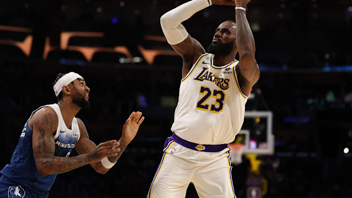 Mar 10, 2024; Los Angeles, California, USA;  Los Angeles Lakers forward LeBron James (23) shoots the ball over Minnesota Timberwolves guard Nickeil Alexander-Walker (9) during the second quarter at Crypto.com Arena. Mandatory Credit: Kiyoshi Mio-Imagn Images