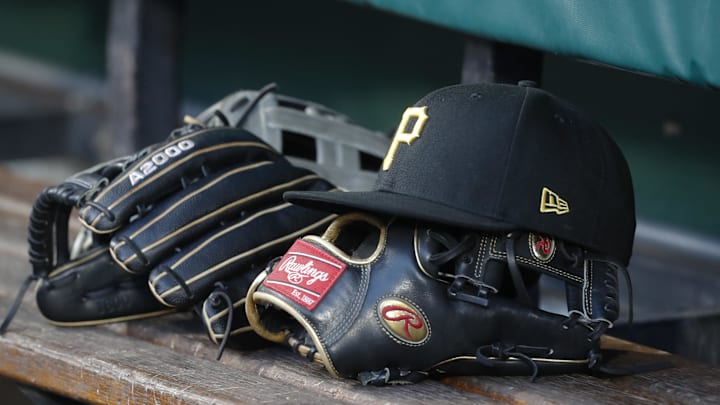 Aug 8, 2023; Pittsburgh, Pennsylvania, USA;  Pittsburgh Pirates hat and gloves in the dugout against