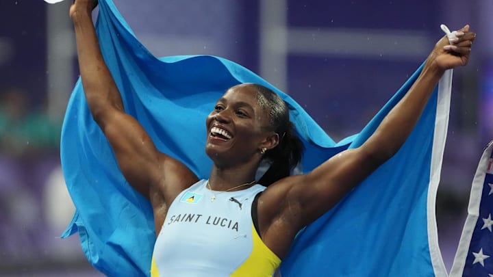 Aug 3, 2024; Paris, FRANCE; Julien Alfred (LCA) celebrates winning the women's 100m final during the Paris 2024 Olympic Summer Games at Stade de France. 