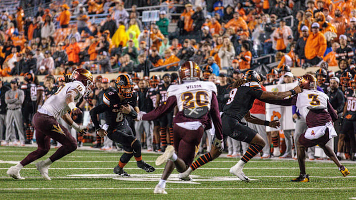 Nov 2, 2024; Stillwater, Oklahoma, USA;  Oklahoma State Cowboys quarterback Maealiuaki Smith (8) runs the ball during the fourth quarter against the Arizona State Sun Devils at Boone Pickens Stadium. Mandatory Credit: William Purnell-Imagn Images