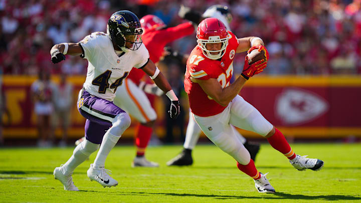 Sep 28, 2025; Kansas City, Missouri, USA; Kansas City Chiefs tight end Travis Kelce (87) rushes as Baltimore Ravens cornerback Marlon Humphrey (44) defends during the first half at GEHA Field at Arrowhead Stadium. Mandatory Credit: Jay Biggerstaff-Imagn Images