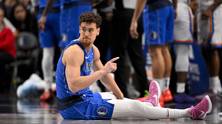 Jan 17, 2025; Dallas, Texas, USA; Dallas Mavericks center Dwight Powell (7) suffers a possible lower body injury during the second half against the Oklahoma City Thunder at the American Airlines Center. Mandatory Credit: Jerome Miron-Imagn Images