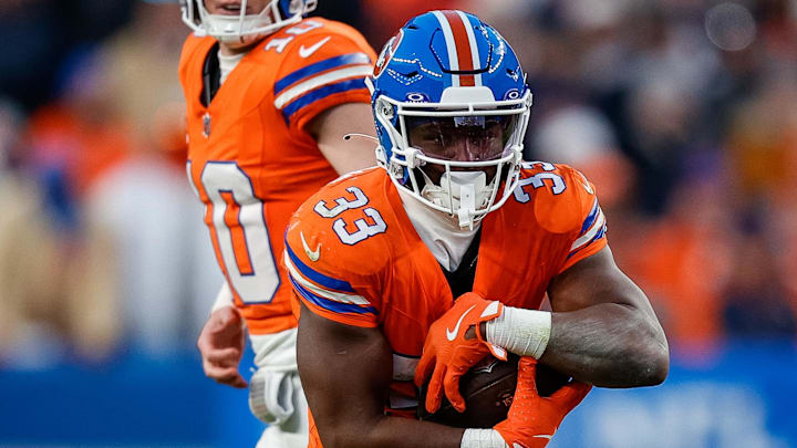 Denver Broncos running back Javonte Williams (33) runs the ball on a handoff from quarterback Bo Nix (10) in the fourth quarter against the Kansas City Chiefs at Empower Field at Mile High in the 2024 season. Denver Broncos running back Javonte Williams (33) runs the ball on a handoff from quarterback Bo Nix (10) in the fourth quarter against the Kansas City Chiefs at Empower Field at Mile High in the 2024 season.