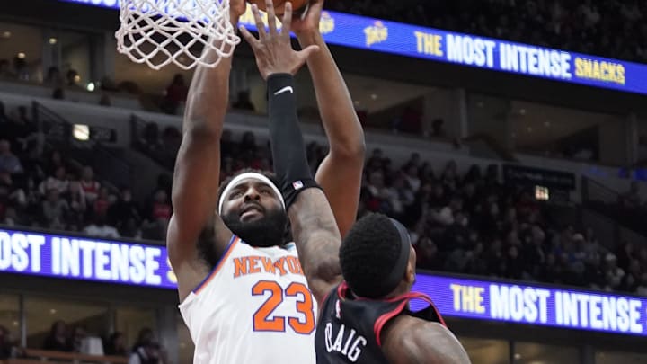 Apr 5, 2024; Chicago, Illinois, USA; New York Knicks center Mitchell Robinson (23) scores against Chicago Bulls forward Torrey Craig (13) during the second half at United Center. Mandatory Credit: David Banks-Imagn Images