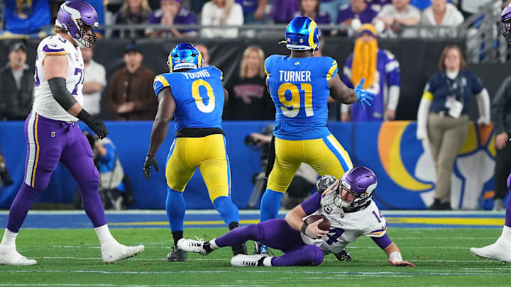 Jan 13, 2025; Glendale, AZ, USA; Los Angeles Rams defensive tackle Kobie Turner (91) reacts after making a sack on Minnesota Vikings quarterback Sam Darnold (14) during the first half in an NFC wild card game at State Farm Stadium. Mandatory Credit: Joe Camporeale-Imagn Images Jan 13, 2025; Glendale, AZ, USA; Los Angeles Rams defensive tackle Kobie Turner (91) reacts after making a sack on Minnesota Vikings quarterback Sam Darnold (14) during the first half in an NFC wild card game at State Farm Stadium. Mandatory Credit: Joe Camporeale-Imagn Images