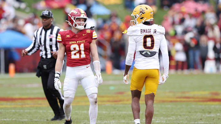 Nov 1, 2025; Ames, Iowa, USA; Arizona State Sun Devils defensive back Rodney Bimage Jr. (0) and Iowa State Cyclones running back Aiden Flora (21) share a verbal exchange during the first half at Jack Trice Stadium. Mandatory Credit: Reese Strickland-Imagn Images Nov 1, 2025; Ames, Iowa, USA; Arizona State Sun Devils defensive back Rodney Bimage Jr. (0) and Iowa State Cyclones running back Aiden Flora (21) share a verbal exchange during the first half at Jack Trice Stadium. Mandatory Credit: Reese Strickland-Imagn Images