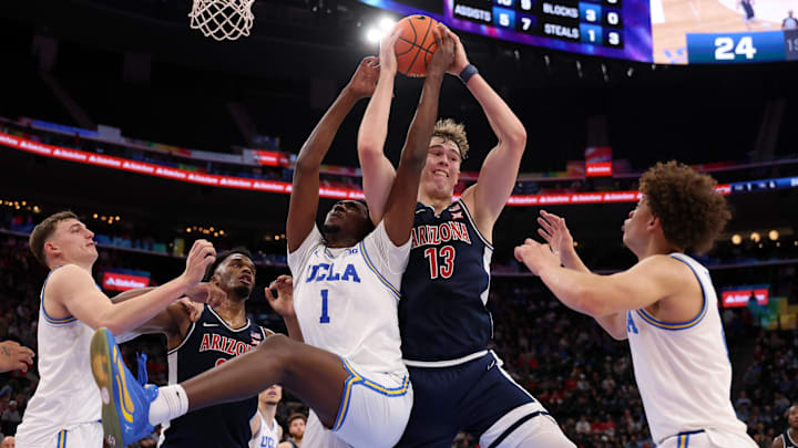 Nov 14, 2025; Inglewood, California, USA;  Arizona Wildcats center Motiejus Krivas (13) fights for a rebound against UCLA Bruins center Xavier Booker (1) during the first half of the Hall of Fame Series game at Intuit Dome. Mandatory Credit: Kiyoshi Mio-Imagn Images