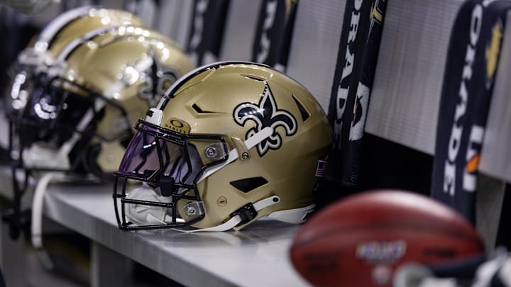 Detailed view of the New Orleans Saints helmets on the team  bench 