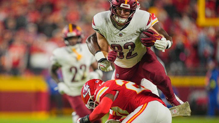 Oct 27, 2025; Kansas City, Missouri, USA; Kansas City Chiefs cornerback Trent McDuffie (22) tackles Washington Commanders tight end Ben Sinnott (82) during the second quarter of the game at GEHA Field at Arrowhead Stadium. Mandatory Credit: Jay Biggerstaff-Imagn Images