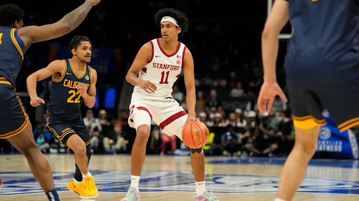 Mar 12, 2025; Charlotte, NC, USA; Stanford Cardinal guard Ryan Agarwal (11) with the ball as California Golden Bears guard Christian Tucker (22) defends in the first half at Spectrum Center. Mandatory Credit: Bob Donnan-Imagn Images