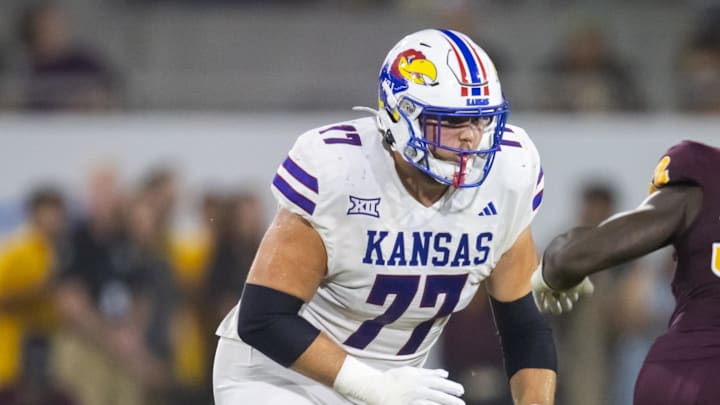 Oct 5, 2024; Tempe, Arizona, USA; Kansas Jayhawks offensive lineman Bryce Cabeldue (77) against the Arizona State Sun Devils at Mountain America Stadium. Mandatory Credit: Mark J. Rebilas-Imagn Images