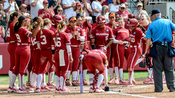 Oklahoma second baseman Ailana Agbayani celebrates with her teammates after hitting a home run against Michigan.