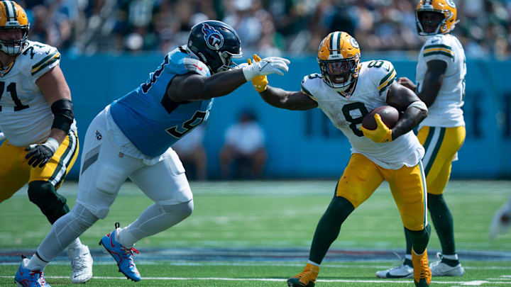 Tennessee Titans defensive tackle T'Vondre Sweat (93) tackles Green Bay Packers running back Josh Jacobs (8) during their game at Nissan Stadium in Nashville, Tenn., Sunday, Sept. 22, 2024.