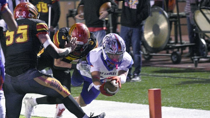 Bulldawg Daniel Amaro dives into the end zone for a touchdown as the Centennial Hawks took on the Las Cruces High Bulldawgs on Friday night at Field of Dreams.