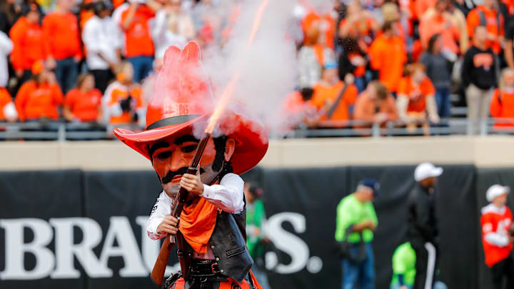 Oct 14, 2023; Stillwater, Oklahoma, USA; Oklahoma State Cowboys mascot Pistol Pete shoots a shotgun during a game between Oklahoma State and Kansas at Boone Pickens Stadium. Mandatory Credit: Nathan J. Fish-Imagn Images