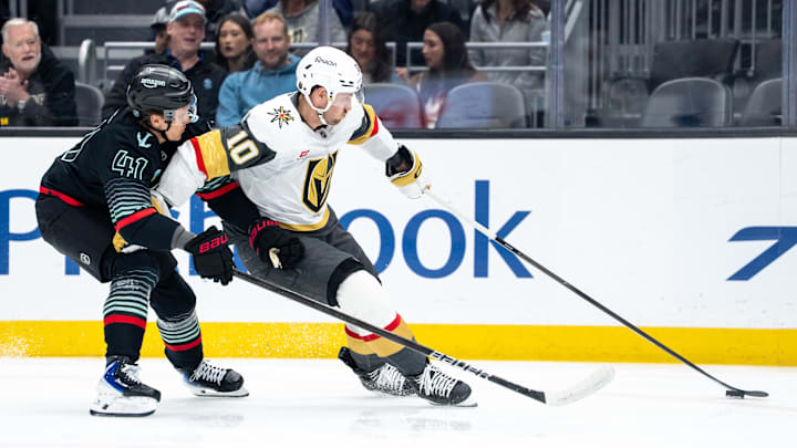 Colton Sissons and Ryker Evans battle for the puck
