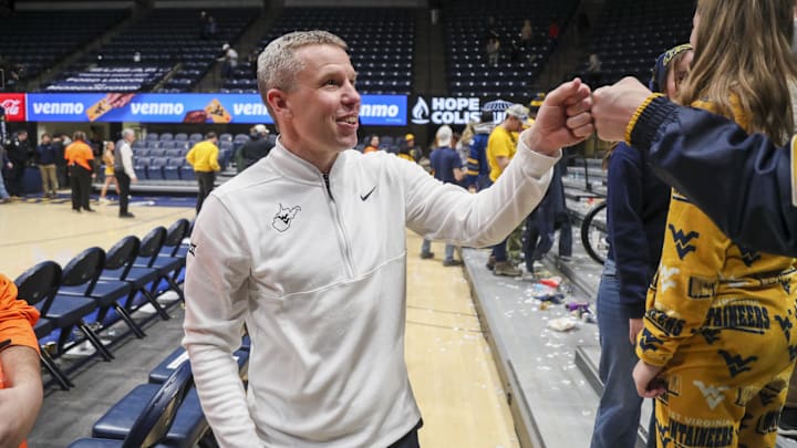 Jan 27, 2026; Morgantown, West Virginia, USA; West Virginia Mountaineers head coach Ross Hodge celebrates with fans after defeating the Kansas State Wildcats at Hope Coliseum. Mandatory Credit: Ben Queen-Imagn Imagesa