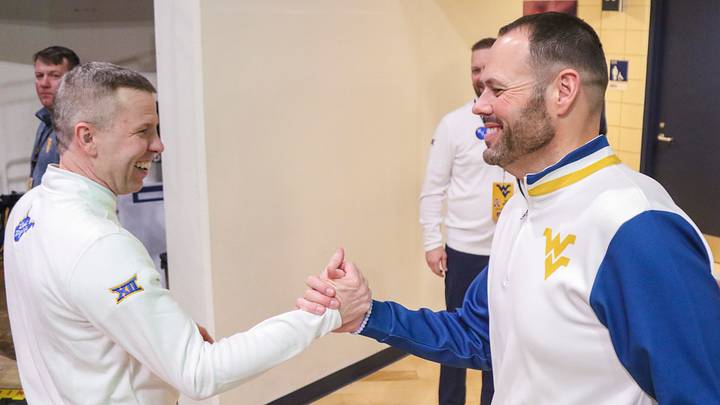 Jan 17, 2026; Morgantown, West Virginia, USA; West Virginia Mountaineers head coach Ross Hodge celebrates with West Virginia Mountaineers Athletic Director Wren Baker after defeating the Colorado Buffaloes at Hope Coliseum. Mandatory Credit: Ben Queen-Imagn Images