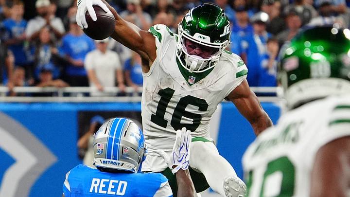 New York Jets tight end Kenyon Sadiq (16) tries to jump over Detroit Lions cornerback D.J. Reed (4) during the second half of the NFL game at Ford Field in Detroit, Sunday, Sept. 27, 2026.