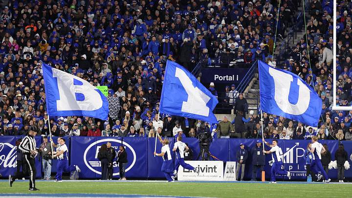 Oct 18, 2024; Provo, Utah, USA; Brigham Young Cougars cheerleaders run with flags after a score against the Oklahoma State Cowboys during the fourth quarter at LaVell Edwards Stadium. Mandatory Credit: Rob Gray-Imagn Images Oct 18, 2024; Provo, Utah, USA; Brigham Young Cougars cheerleaders run with flags after a score against the Oklahoma State Cowboys during the fourth quarter at LaVell Edwards Stadium. Mandatory Credit: Rob Gray-Imagn Images