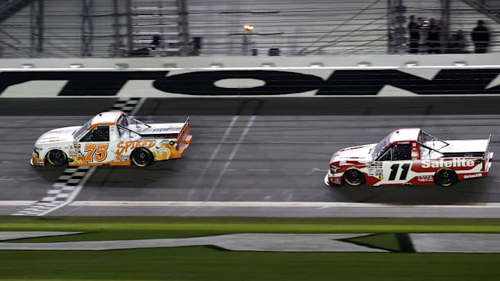 Parker Kligerman (75) initially was credited with the win in Friday night's Fresh From Florida 250, but his truck failed post-race inspection and Corey Heim (11) was named the winner.