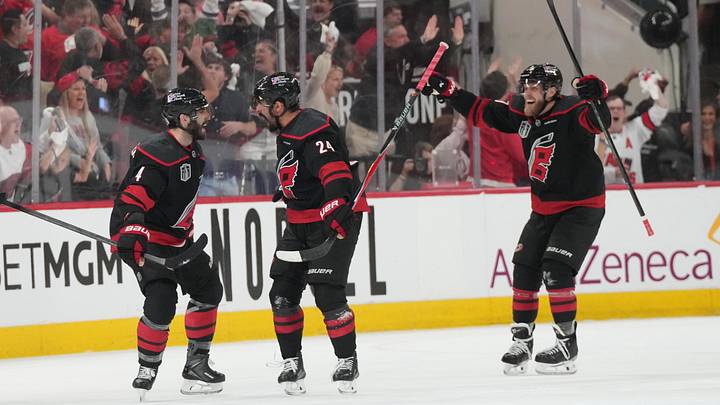 Jun 4, 2026; Raleigh, North Carolina, USA; Carolina Hurricanes right wing Seth Jarvis (24) celebrates scoring with defenseman Shayne Gostisbehere (4) in overtime against the Vegas Golden Knights in game two of the 2026 Stanley Cup Final at Lenovo Center. Mandatory Credit: James Guillory-Imagn Images