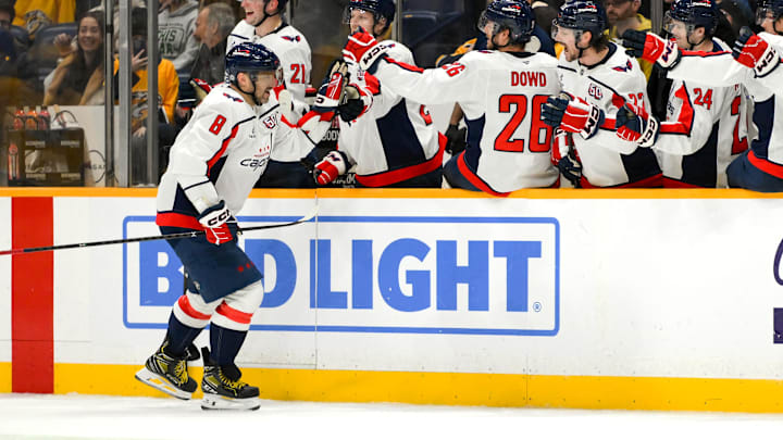 Jan 11, 2025; Nashville, Tennessee, USA;  Washington Capitals left wing Alex Ovechkin (8) celebrates with teammates after scoring a goal against the Nashville Predators during the third period at Bridgestone Arena. Mandatory Credit: Steve Roberts-Imagn Images