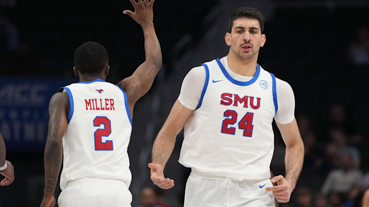 Mar 10, 2026; Charlotte, NC, USA; Southern Methodist University Mustangs center Samet Yigitoglu (24) reacts with guard Boopie Miller (2) in the first half at Spectrum Center. Mandatory Credit: Bob Donnan-Imagn Images Mar 10, 2026; Charlotte, NC, USA; Southern Methodist University Mustangs center Samet Yigitoglu (24) reacts with guard Boopie Miller (2) in the first half at Spectrum Center. Mandatory Credit: Bob Donnan-Imagn Images