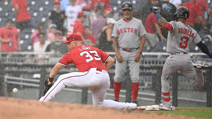 Jul 6, 2025; Washington, District of Columbia, USA; Boston Red Sox center fielder Ceddanne Rafaela (3) is safe at first base in front of Washington Nationals first baseman Nathaniel Lowe (33) before the rain delay during the second inning at Nationals Park. Mandatory Credit: Rafael Suanes-Imagn Images
