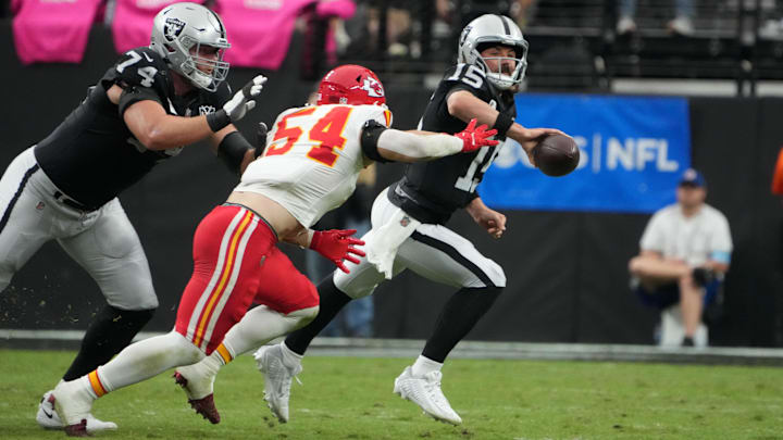 Oct 27, 2024; Paradise, Nevada, USA; Las Vegas Raiders quarterback Gardner Minshew (15) throws the ball against Kansas City Chiefs linebacker Leo Chenal (54) in the first half at Allegiant Stadium. Mandatory Credit: Kirby Lee-Imagn Images