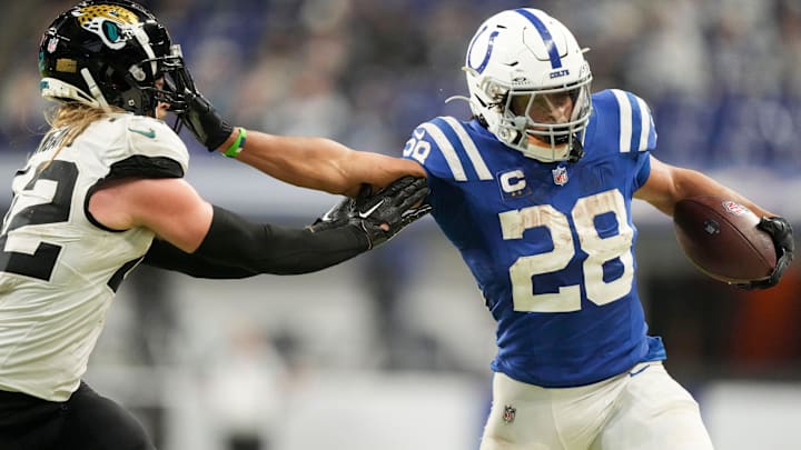 Indianapolis Colts running back Jonathan Taylor (28) pushes off Jacksonville Jaguars cornerback De'Antre Prince (24) as he rushes the ball Sunday, Jan. 5, 2025, during a game against the Jacksonville Jaguars at Lucas Oil Stadium in Indianapolis.