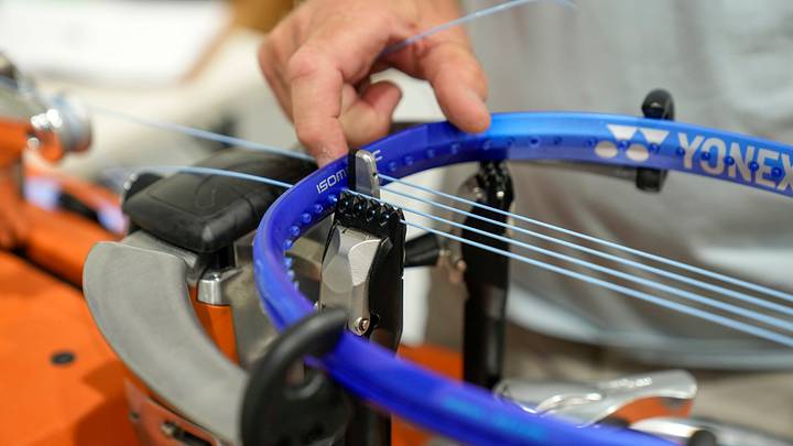 Professional racket stringer Tom Parry weaves new string into a racket at the Lindner Family Tennis Center in Mason, Ohio, on Tuesday, Aug. 12, 2025. Professional racket stringer Tom Parry weaves new string into a racket at the Lindner Family Tennis Center in Mason, Ohio, on Tuesday, Aug. 12, 2025.