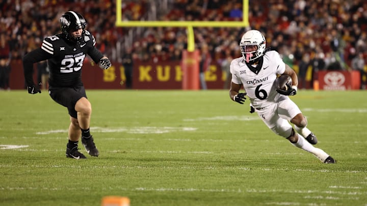 Nov 16, 2024; Ames, Iowa, USA; Cincinnati Bearcats running back Evan Pryor (6) runs away from Iowa State Cyclones  Carson Robbins (23) in the first half at Jack Trice Stadium. Mandatory Credit: Reese Strickland-Imagn Images