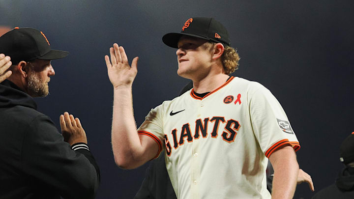 Jul 31, 2024; San Francisco, California, USA; San Francisco Giants starting pitcher Logan Webb (62) high fives teammates after pitching a complete game against the Oakland Athletics at Oracle Park. 
