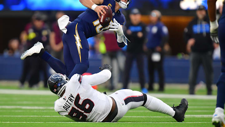 Dec 27, 2025; Inglewood, California, USA; Los Angeles Chargers quarterback Justin Herbert (10) is sacked by Houston Texans defensive end Denico Autry (96) during the first half at SoFi Stadium. Mandatory Credit: Gary A. Vasquez-Imagn Images Dec 27, 2025; Inglewood, California, USA; Los Angeles Chargers quarterback Justin Herbert (10) is sacked by Houston Texans defensive end Denico Autry (96) during the first half at SoFi Stadium. Mandatory Credit: Gary A. Vasquez-Imagn Images