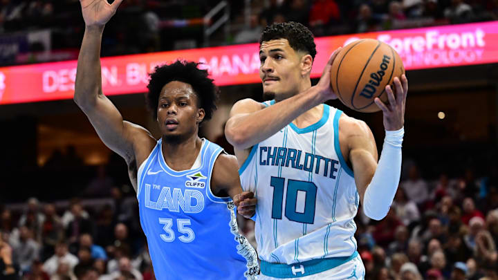 Nov 17, 2024; Cleveland, Ohio, USA; Charlotte Hornets guard Josh Green (10) drives to the basket against Cleveland Cavaliers forward Isaac Okoro (35) during the first half at Rocket Mortgage FieldHouse. Mandatory Credit: Ken Blaze-Imagn Images