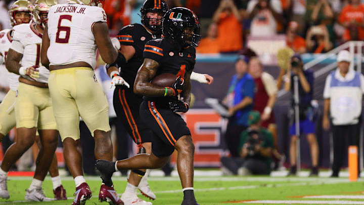 Oct 26, 2024; Miami Gardens, Florida, USA; Miami Hurricanes running back Mark Fletcher Jr. (4) runs with the football for a touchdown against the Florida State Seminoles during the first quarter at Hard Rock Stadium. Mandatory Credit: Sam Navarro-Imagn Images