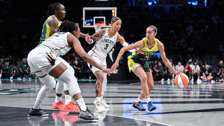 Jul 6, 2025; Brooklyn, New York, USA; Seattle Storm guard Skylar Diggins (4) dribbles the ball defended by New York Liberty guard Natasha Cloud (9) and forward Kennedy Burke (22) during the first half at Barclays Center. Mandatory Credit: John Jones-Imagn Images