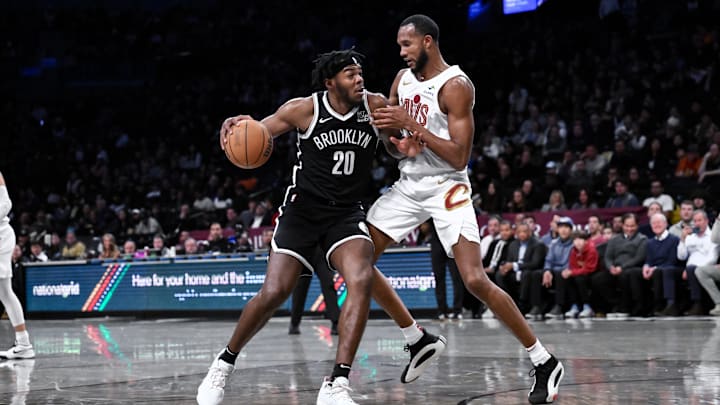 Feb 20, 2025; Brooklyn, New York, USA; Brooklyn Nets center Day'Ron Sharpe (20) posts up against Cleveland Cavaliers forward Evan Mobley (4) during the first half at Barclays Center. Mandatory Credit: John Jones-Imagn Images